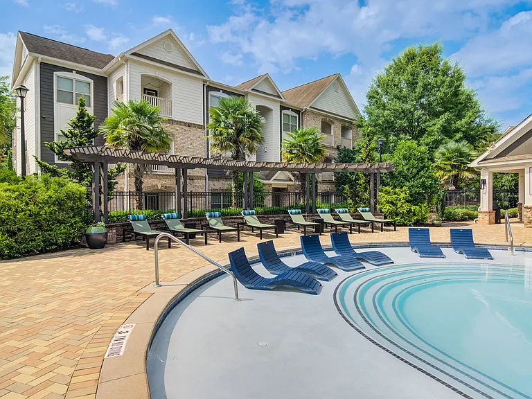 Sundeck with lounge chairs at Waterstone at Big Creek apartments for rent in Alpharetta, GA