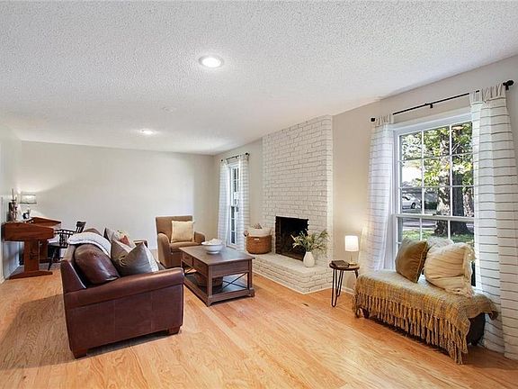 New hardwood floors throughout first level! Big living room with windows down to the floor!