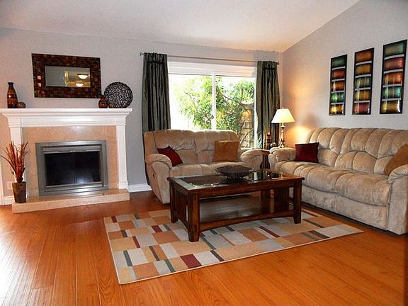Living room with vaulted ceiling and custom fireplace