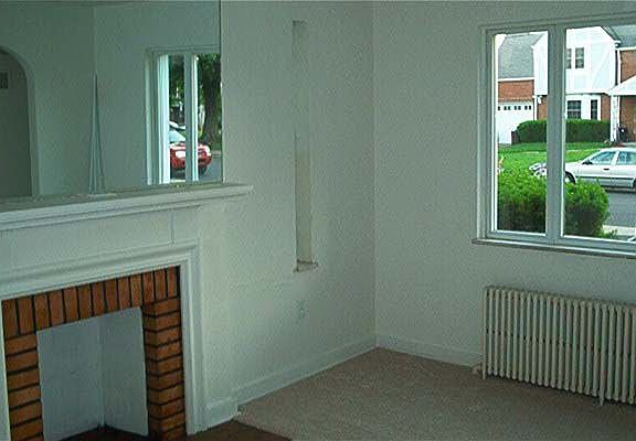 Living room features fireplace and large window to keep it light and bright!