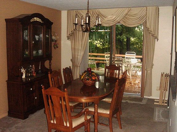 The classy & elegant dining room opens to the peaceful & private back deck.