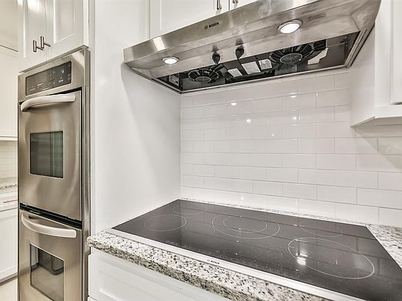 Enjoy cooking on the induction cook-top with vent hood and SS double ovens.