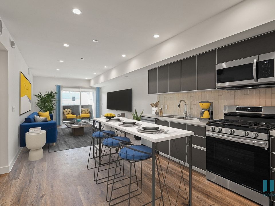 Open-Concept Kitchen, Dining, And Living Room with Patio