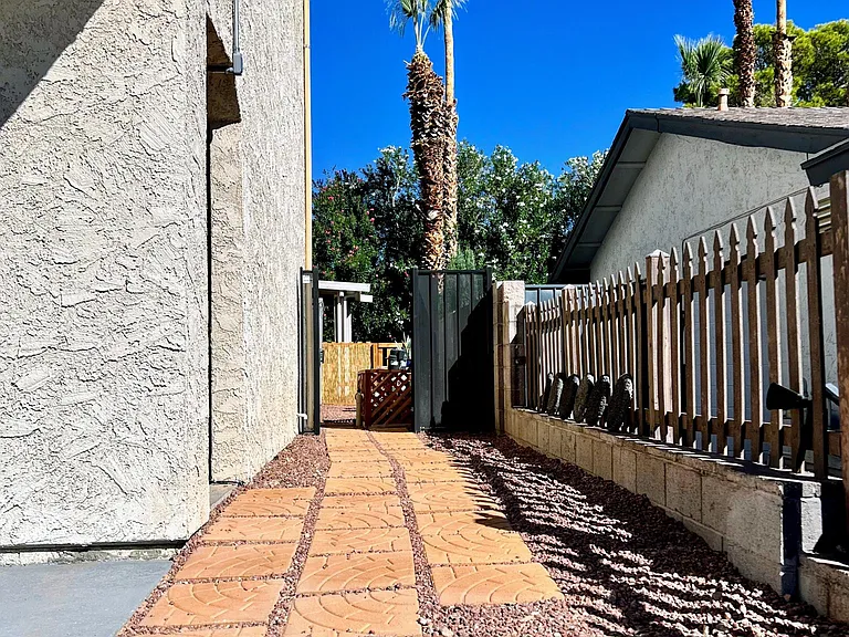 Entryway. Please note the black gate (and pool equipment) have been removed.