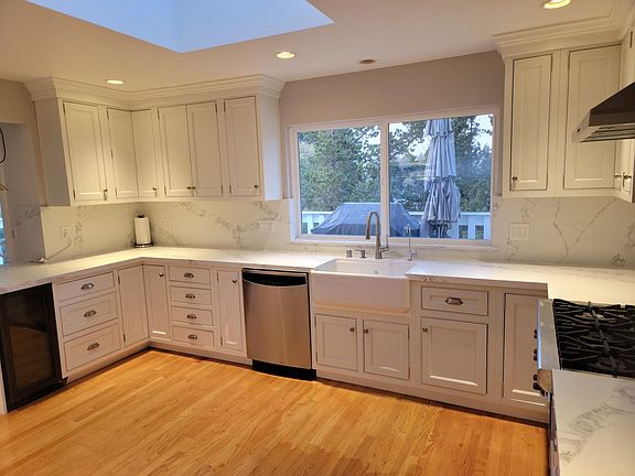 Plenty of counter space with view of trees and balcony