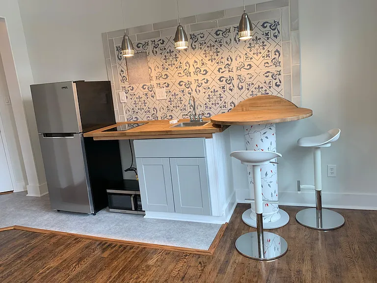 Shelves will be incorporated in the space where the microwave is located. Also shelves above the table and refrigerator