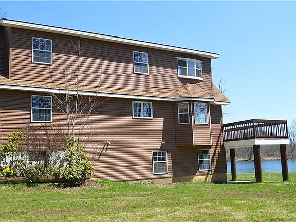Side of home with flat yard and easy to maintain landscaping