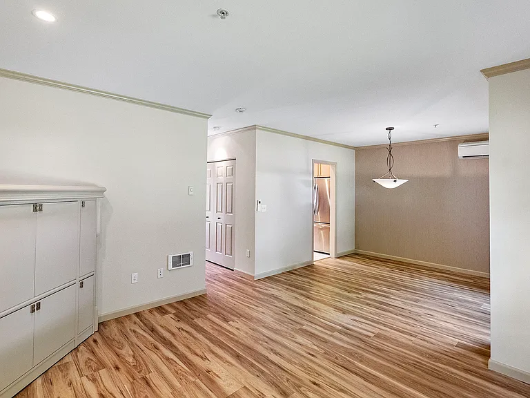 Living/dining area with newer LVP flooring and built-in storage
