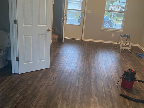 Living room with vinyl plank flooring and half bath