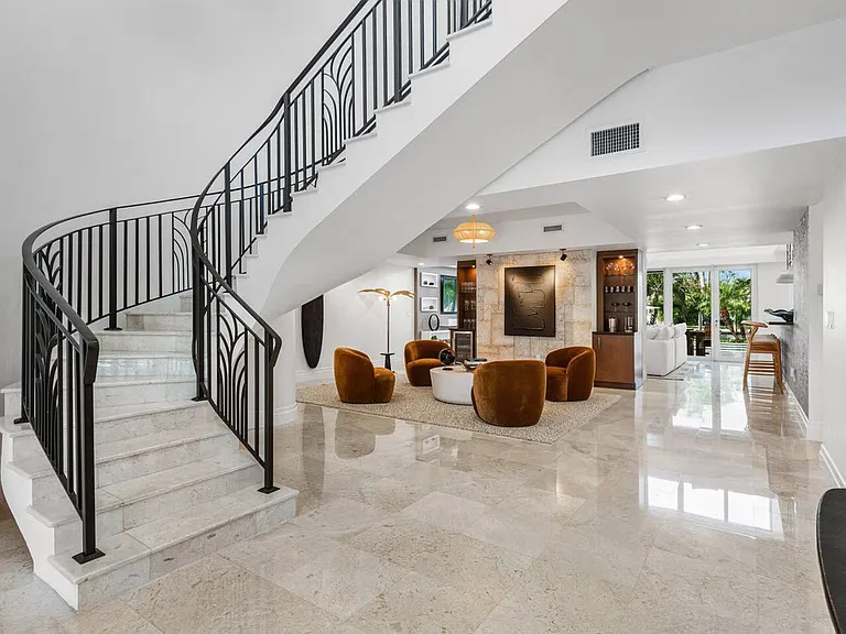 Grand staircase with timeless wrought-iron railings and smooth marble steps, a true focal point.