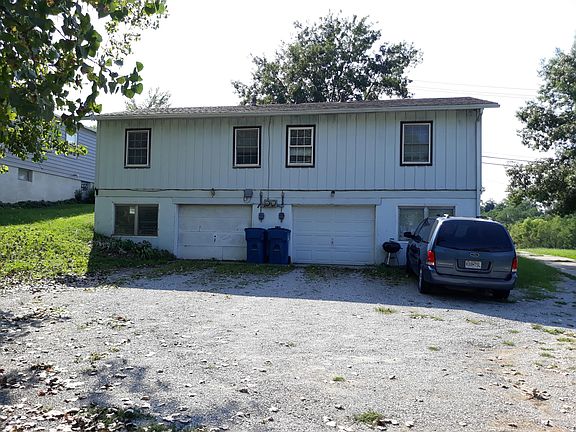 back view with drive-in basement garage