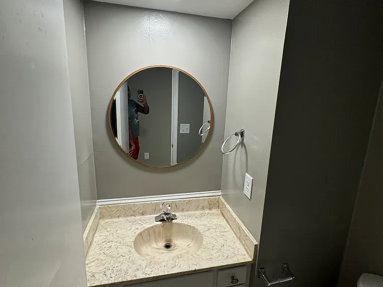 powder room in the main floor with new vanity mirror, fresh paint