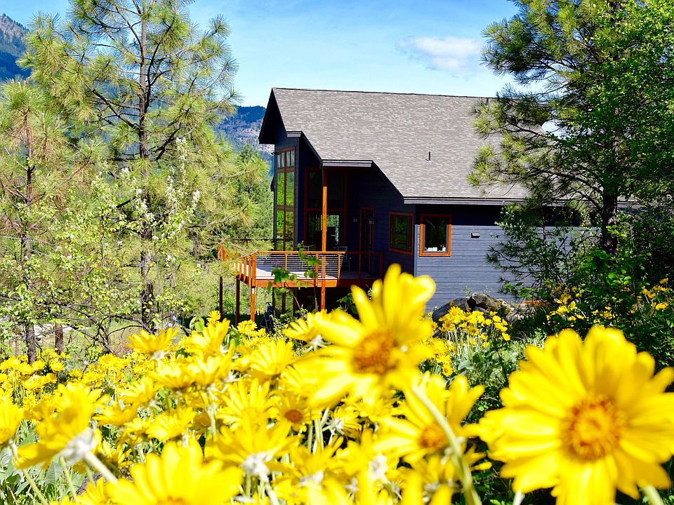 As seen from behind the house on the property. Home is located on 5 hillside acres.