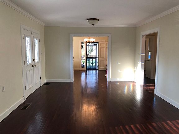 Living room with front door on left, looking into dining room