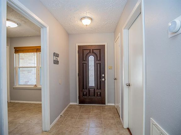 Lovely front door, tile and wood flooring throughout and current paint tones.