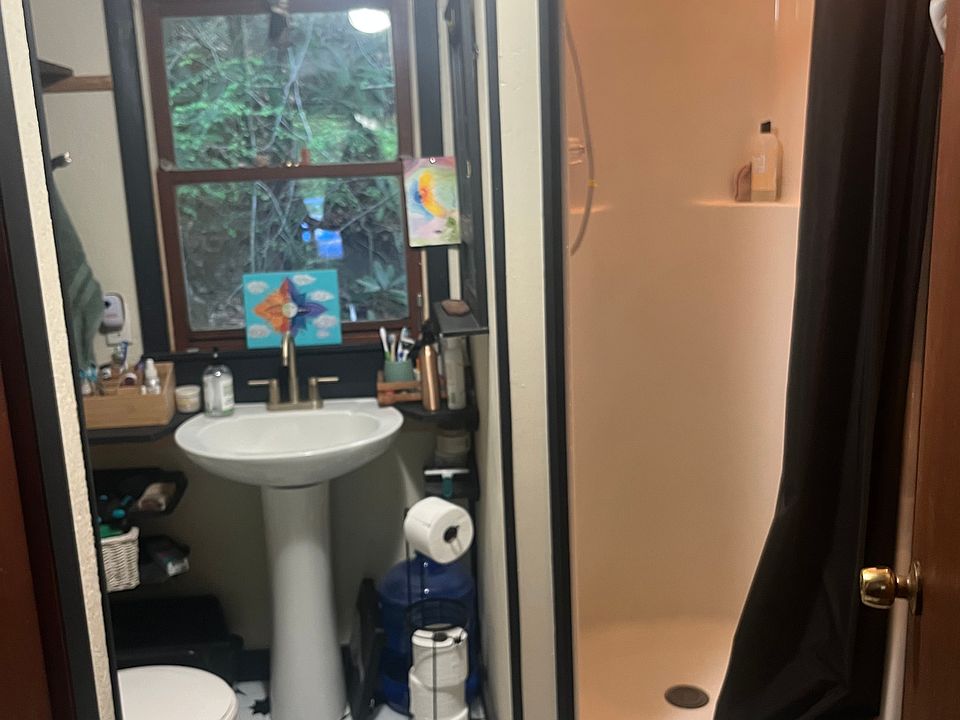 updated bathroom with shelf storage and small closet