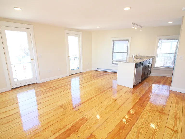 Unfurnished living room and kitchen open-concept space.