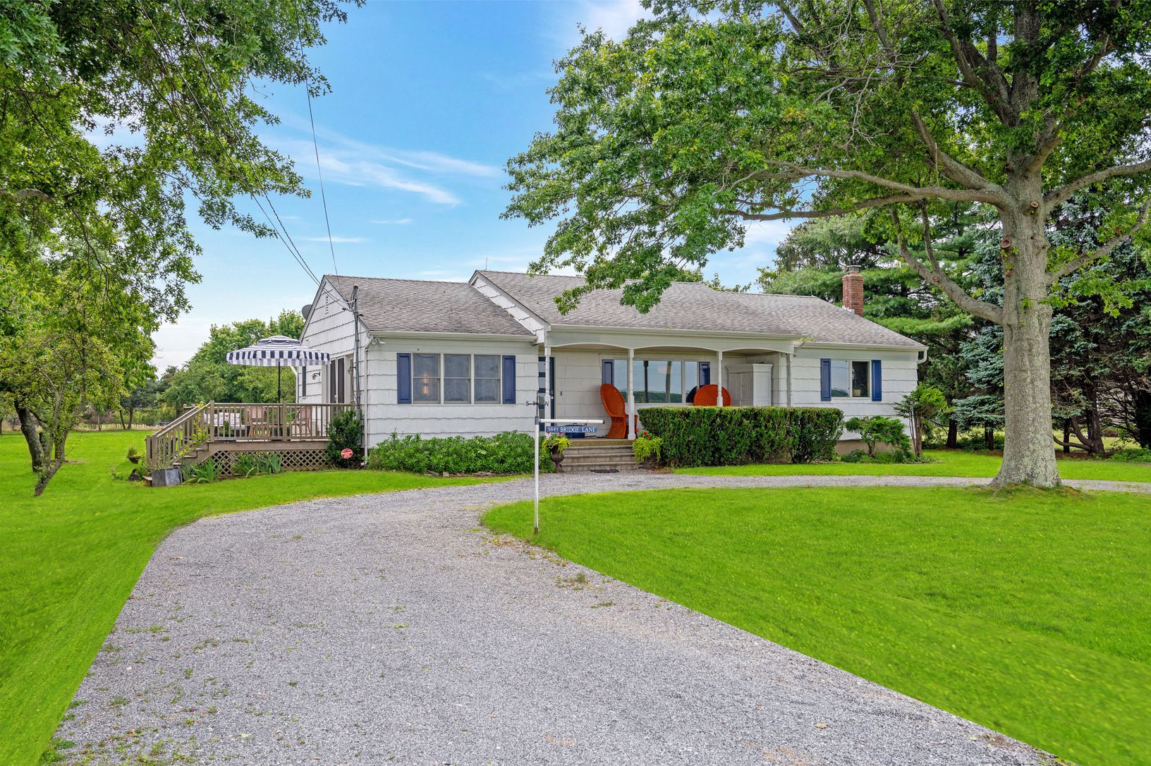 Summer View of Single Floor Ranch with Full Basement & Circular Driveway