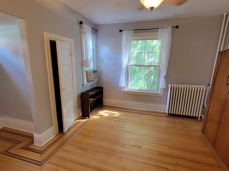 Large living room with lots of closet space, alcove, large windows, and light.