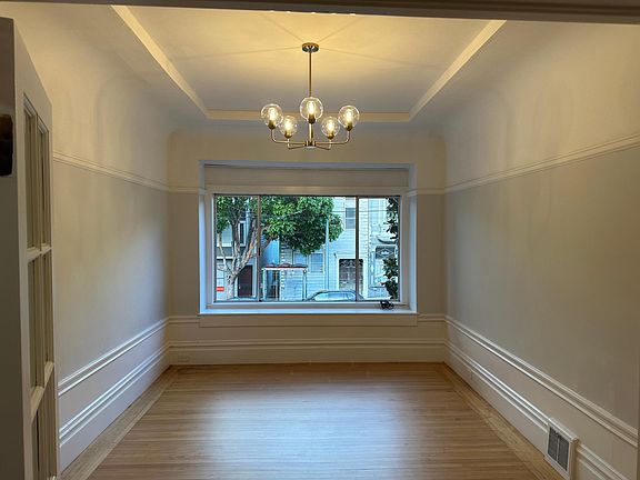The adjacent living room faces Church Street and features a vaulted ceiling and other period details.