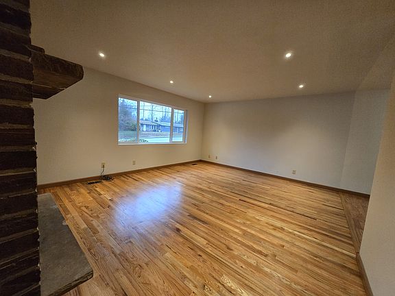 Living Room. New real hardwoods and double paned picture window. New and modern recessed lighting.