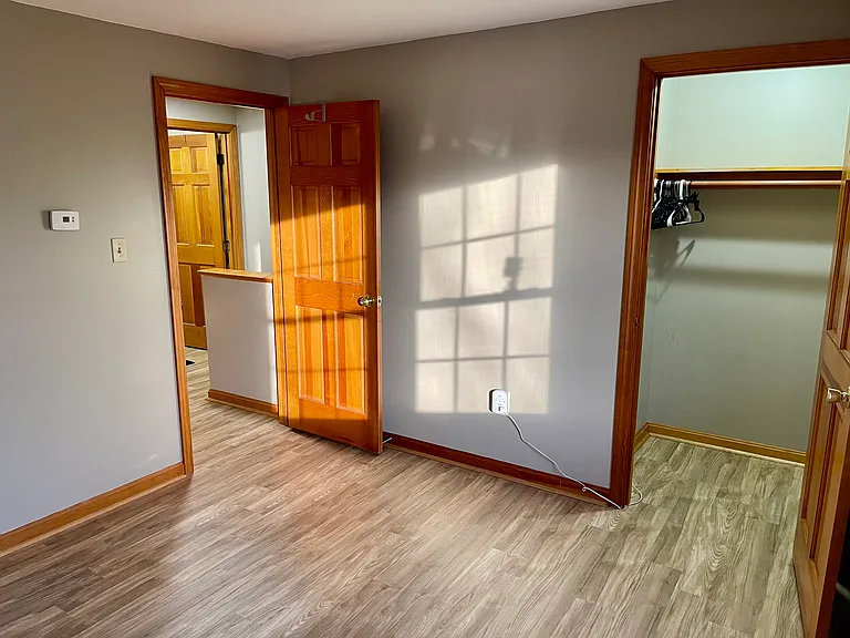 Available room, closet, view to the bathroom door