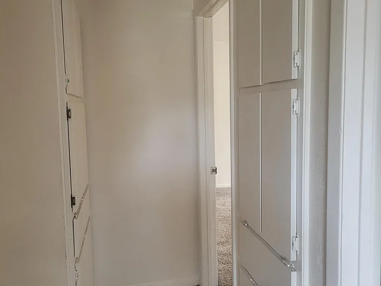 Hall with two sets of linen cabinets