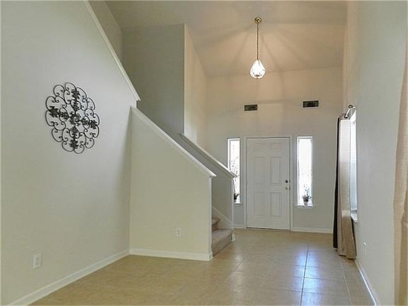Two story entrance and high ceilings in this living room.