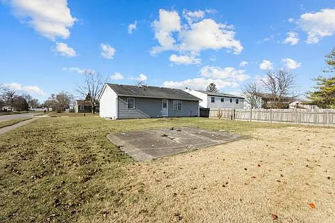view of backyard + concrete pad