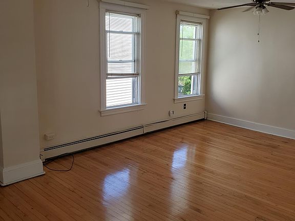 living room with 4 windows and hardwood floor