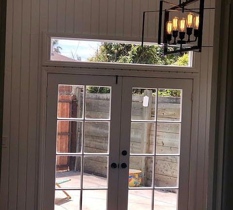 french doors and transom window let in tons of natural sunlight