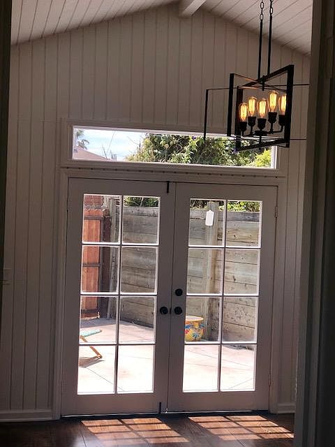french doors and transom window let in tons of natural sunlight