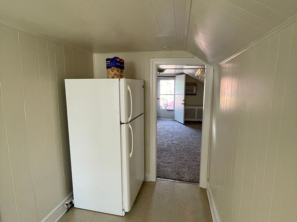 Kitchen hallway with refrigerator.