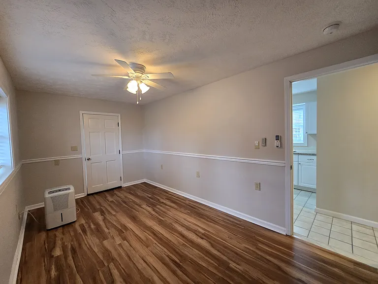 Bedroom 1 with exit access to small back patio