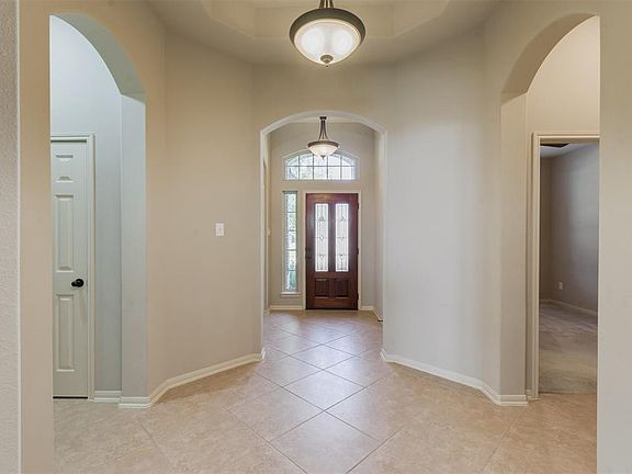 Detailed ceilings, updated lighting, and neutral tile floors that extend into the gallery.