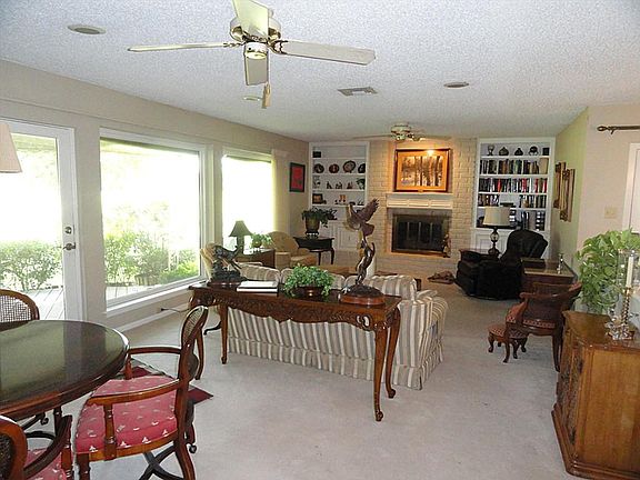 Large family room has built ins and huge windows overlooking the golf course.