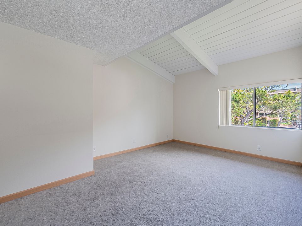 ain bedroom with high ceilings and natural lighting