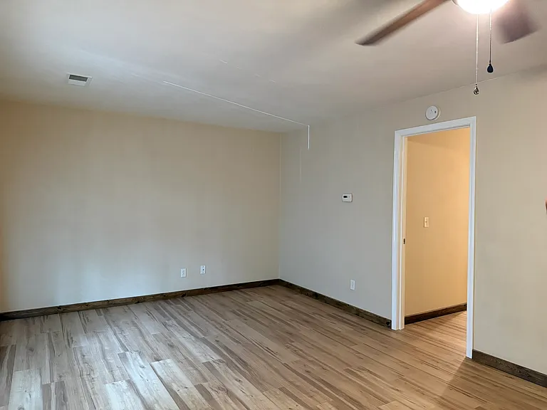 Living room with door to bedroom