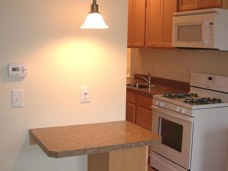 Breakfast bar looking into open floorplan kitchen