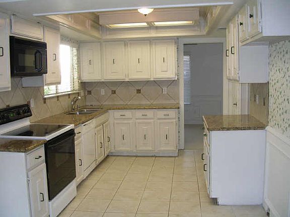 Note this beautiful kitchen with granite counter tops and custom tile work.