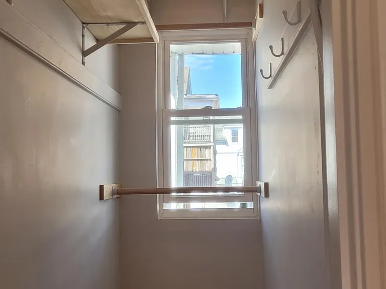 Walk in closet in small bedroom