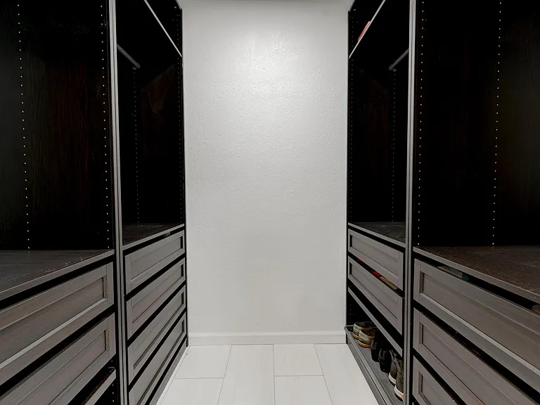 Organized closet system with shoe racks.