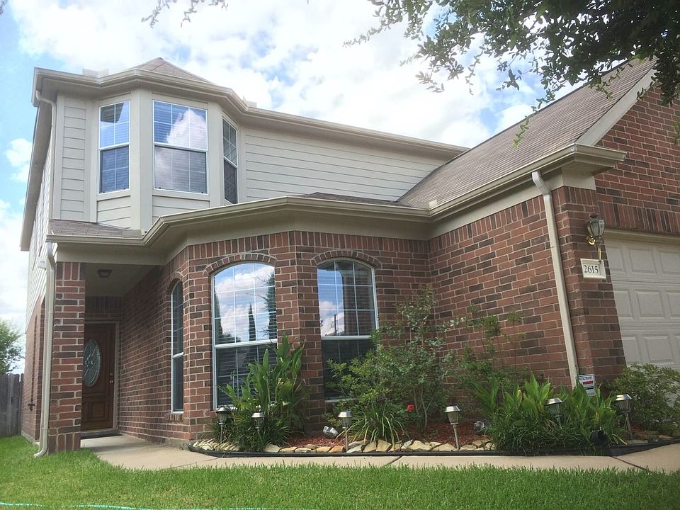 Front elevation - beautiful flower bed and bay window