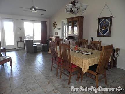 Dining area view of great room. : Dining area with chandelier. Seating area overlooks deck, valley a