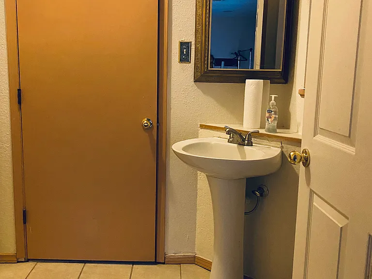 Half restroom located by large family room and kitchen