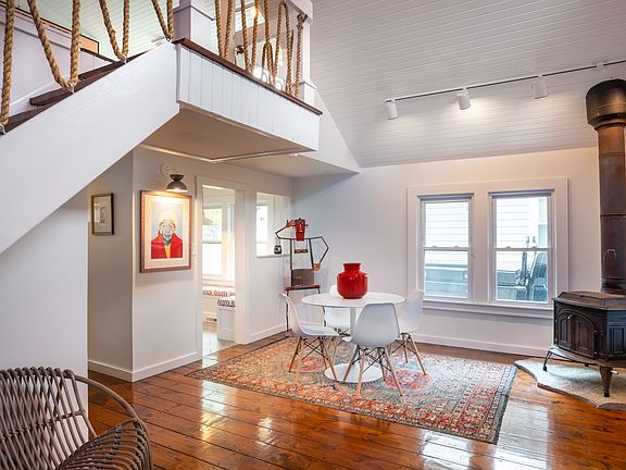 First floor sitting and dining area, with steps to the loft space.