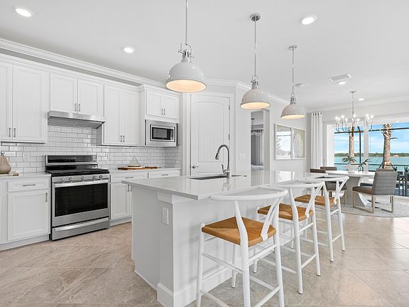 Gourmet kitchen with center island and stainless steel appliances