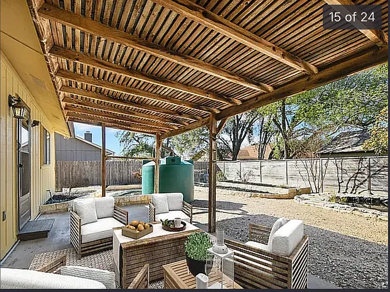 Outside area with raised planting beds and 2 1000 gallon rainbarrels