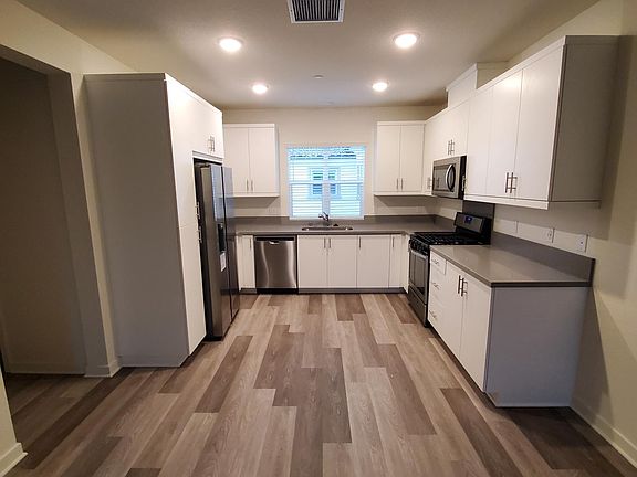 Kitchen with stainless steel appliances including refrigerator