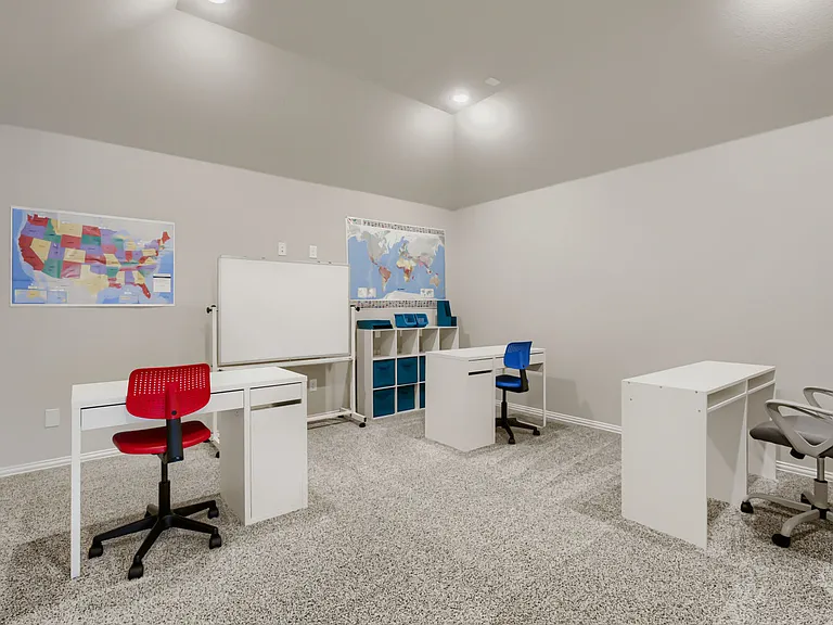 Spacious room with light-toned wall paint and textured carpeting
